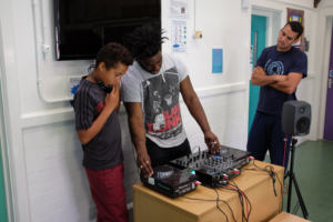 image of DJ tutor teaching participant