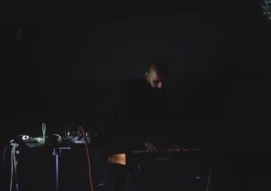 Photo of artist Raheel Khan using sound equipment