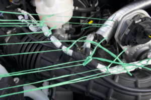 Photo of strings entwined with a machine used in Raheel Khan's In Harmony installation