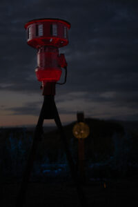 Photo of Warning Notes - a red siren at dusk.