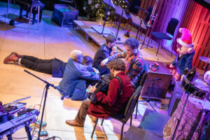 Group shot on stage with puppet figure, from above