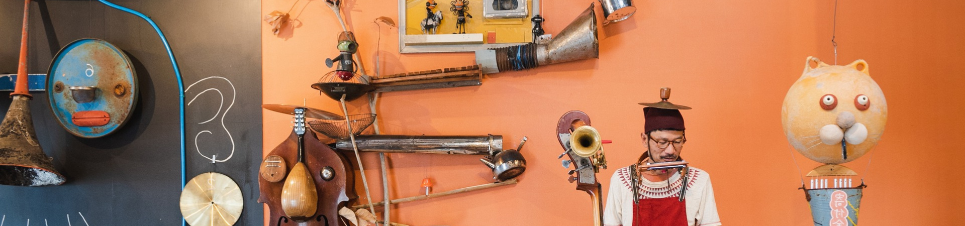 Performer in a workshop with pieces of musical instruments