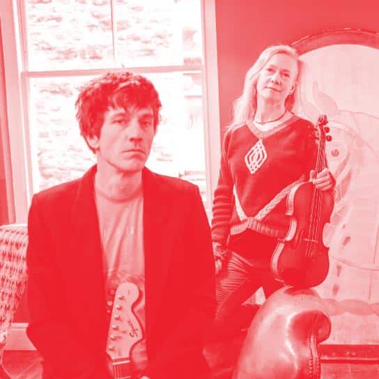 Red image of the duo Peiriant holding fiddle and guitar